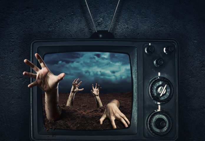 Zombie hand out of TV